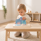 Toddler placing a chunky blue elephant piece into the wooden animal puzzle