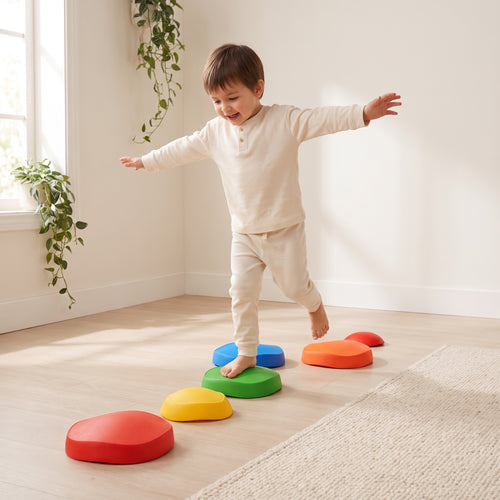 Child balancing barefoot across a winding line of dome stepping stones