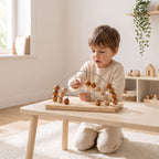 Child sliding beads along the wire of the wooden counting frame