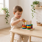 Child threading a yellow disc onto a peg of the Montessori cylinder block set