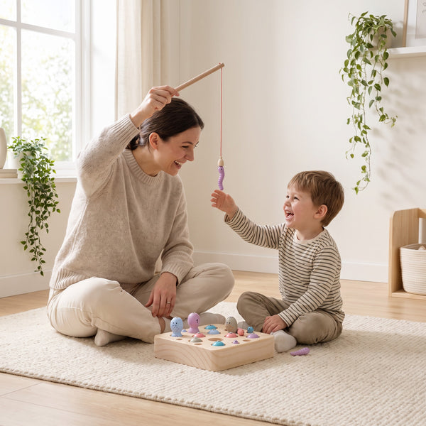 Parent and child playing the magnetic fishing game together on the rug