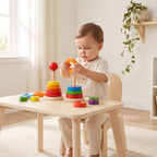 Toddler threading an orange ring onto the peg of the double ring stacker