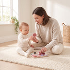 Parent naming shapes with their baby using the soft silicone shape stacker