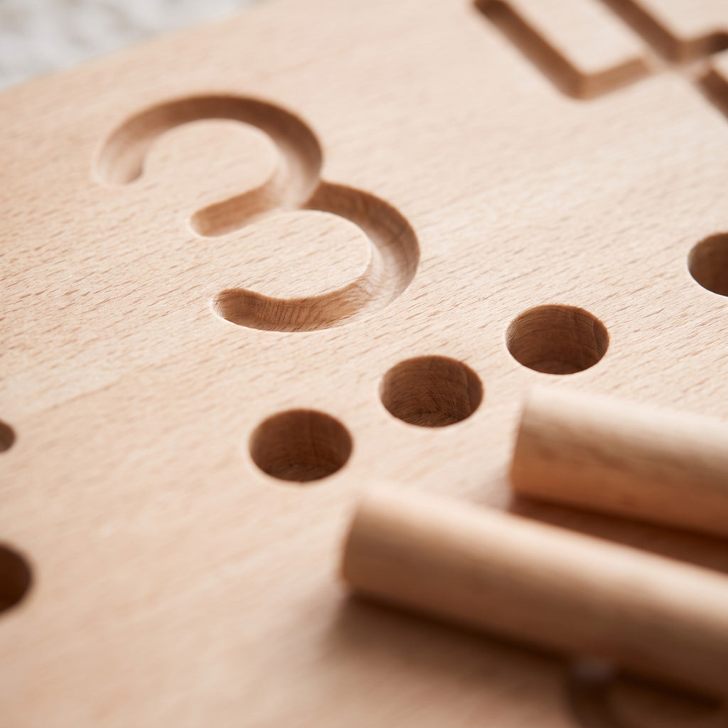 Macro of the engraved numeral 3 groove and counting holes on the birch tracing board