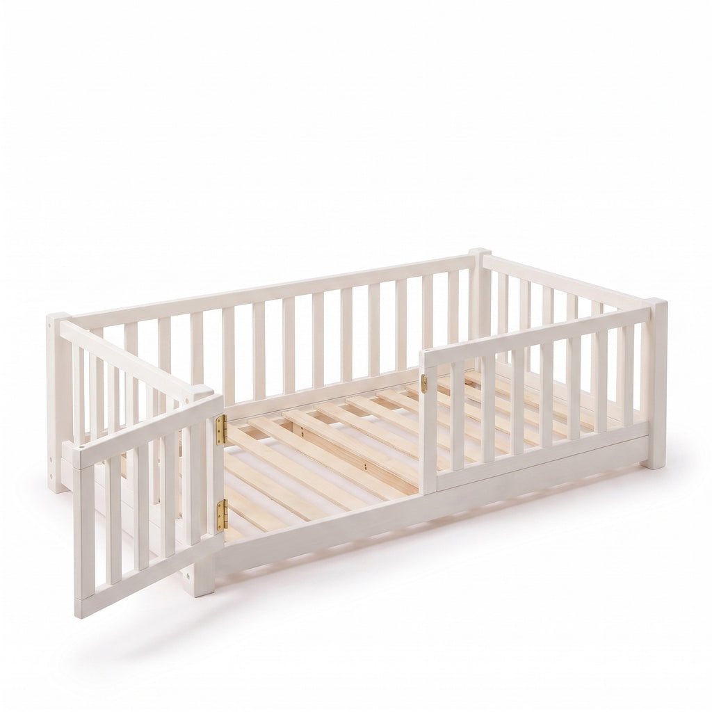 Twin size white Montessori floor bed with the front-left gate swung open, showing brass hinges and natural wood slats
