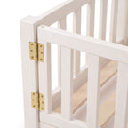 Close-up of the brass barrel hinges on the gate of the white Montessori floor bed
