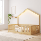 Twin size natural wood Montessori floor bed with LED lights, made up with cream bedding in a bright Scandinavian nursery