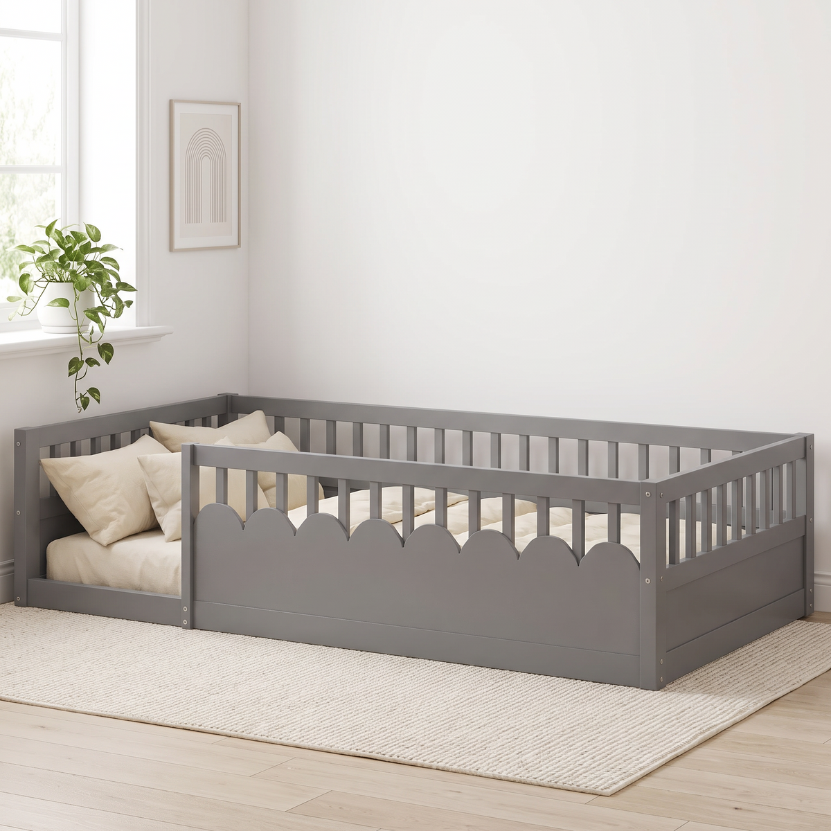 Twin grey Montessori floor bed seen from the foot end, showing the full guardrail frame and open doorway