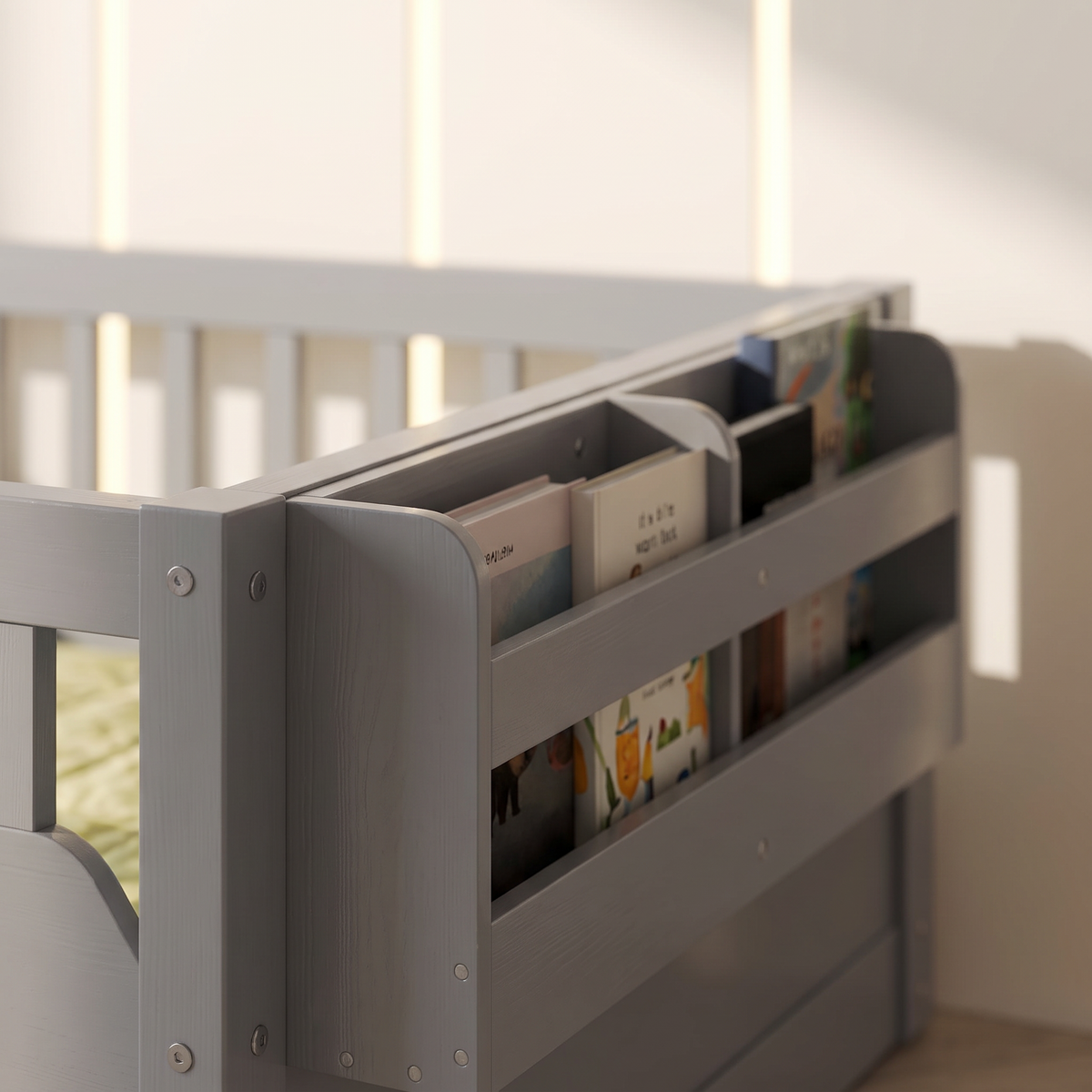 Close-up of the side storage shelf on the grey Montessori floor bed holding picture books