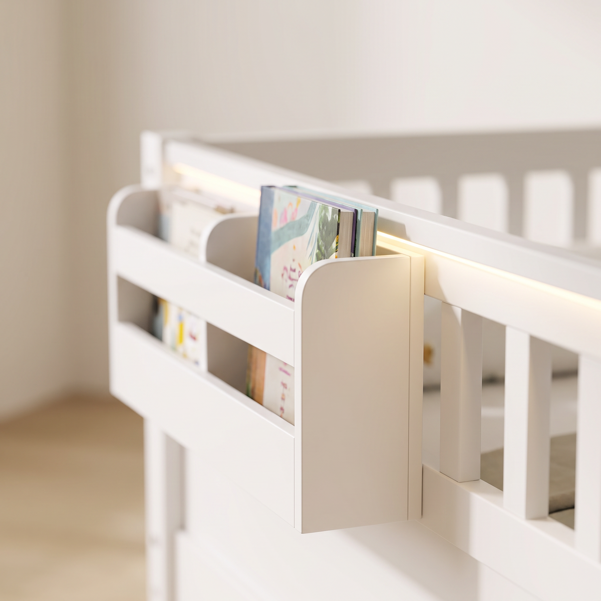 Close-up of the side storage shelf on the white Montessori floor bed holding picture books