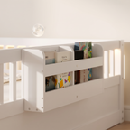 Close-up of the side storage shelf on the white Montessori floor bed holding picture books