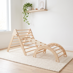 Natural wood Pikler triangle set assembled with arch and ramp on a cream rug in a bright Scandinavian nursery